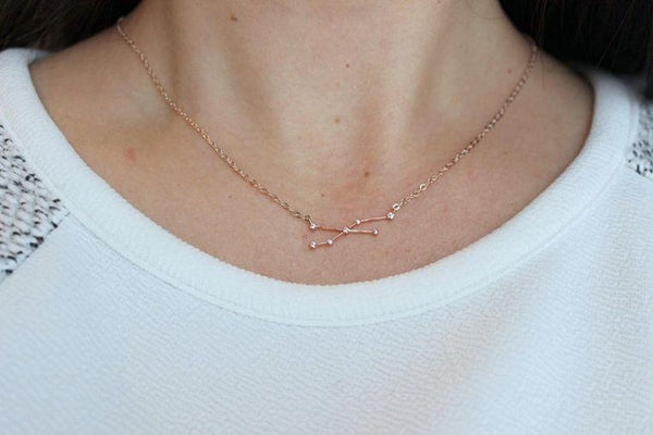 Let your personality shine with this gold zodiac constellation necklace. Unique celestial gift for your wedding party or the astrology lover in your life. 14K gold filled 16.5" necklace. Includes gift box for easy gifting. Aries, Taurus, Gemini, Cancer, Leo, Virgo, Libra, Scorpio, Sagittarius, Capricorn, Aquarius, Pisces.